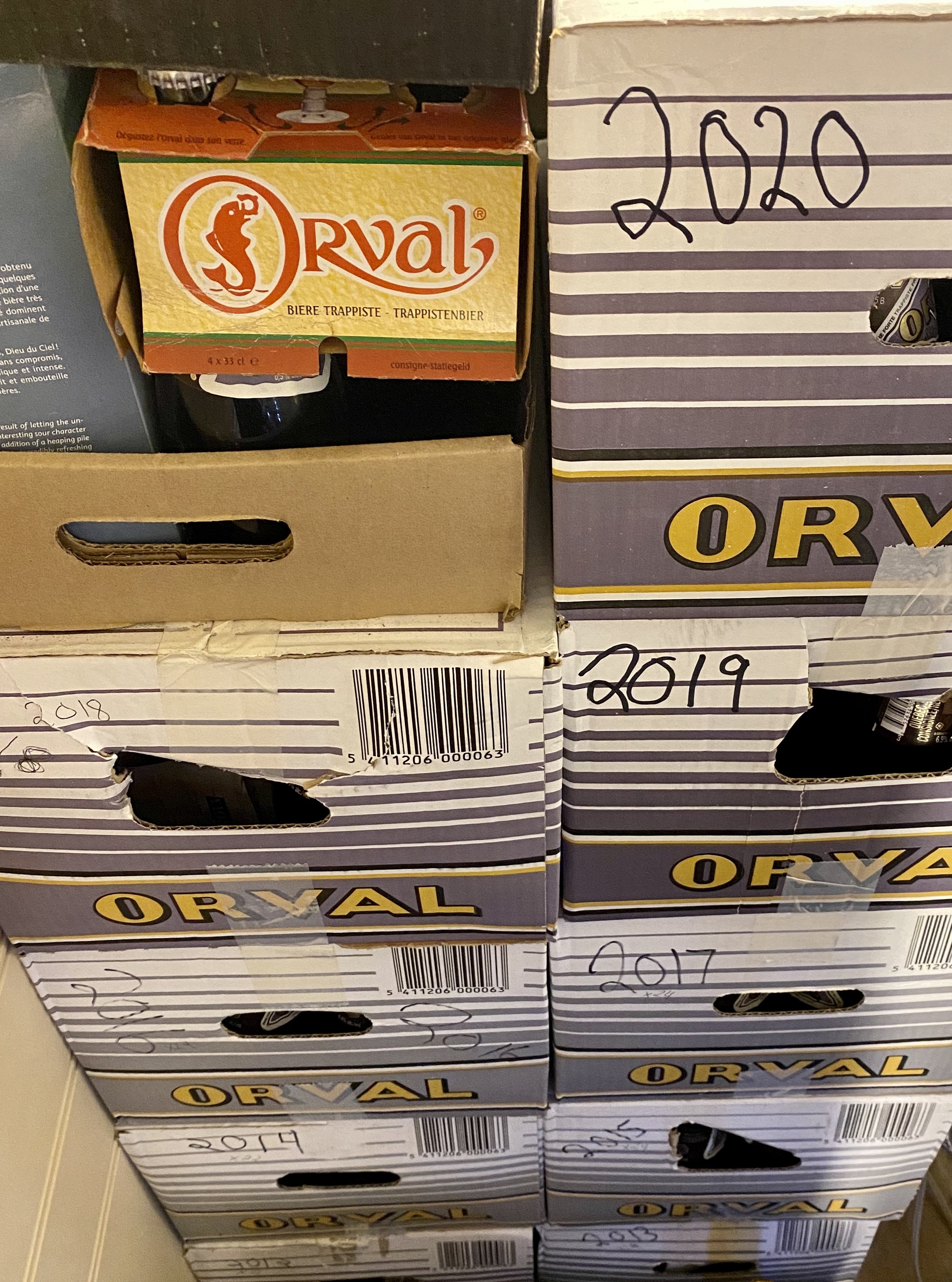A wall of cases of Orval.